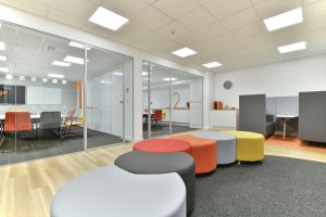 office fit out with glass meeting rooms and vibrant furniture
